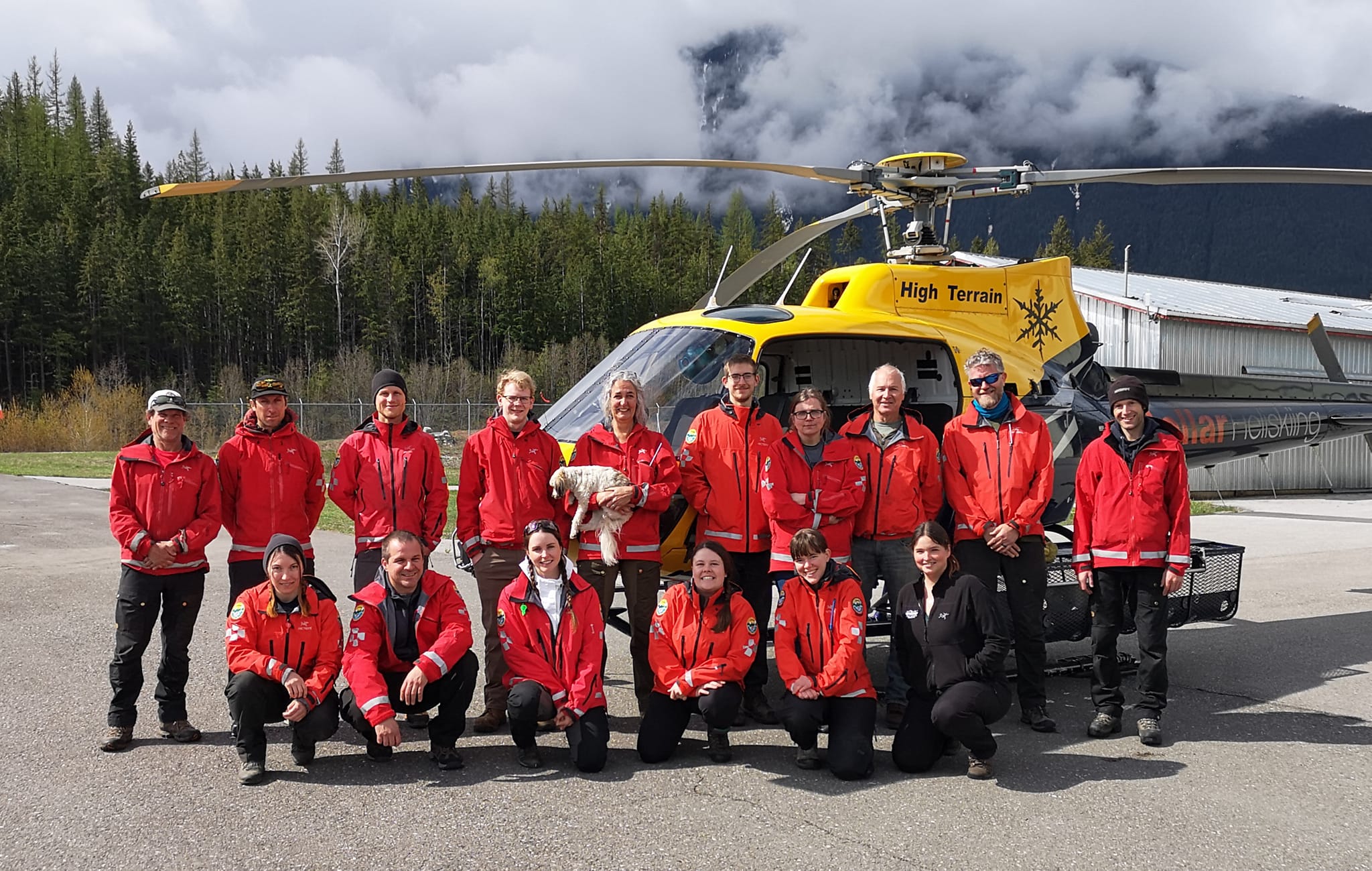 Team photo in front of a helictopter